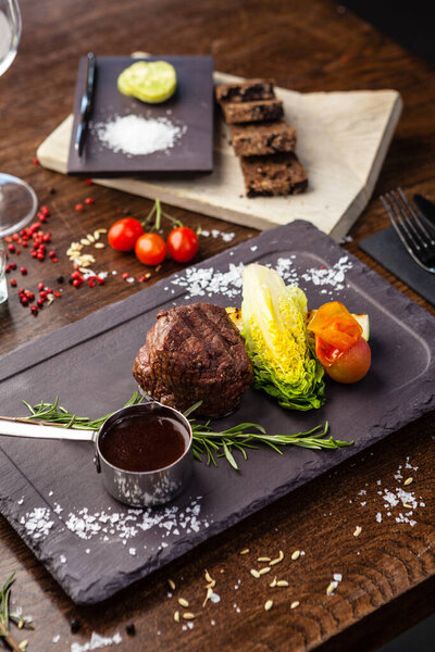 Black Angus Chateaubriant steak. Tenderloin from Brazil. Delicious healthy traditional food closeup served for lunch in modern gourmet cuisine restaurant.