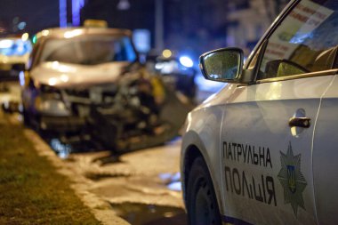 Car crash accident on street with wreck and damaged automobiles after collision. Patrol Police Car Closeup. Ukraine, Kharkiv, 28.11.2020 clipart