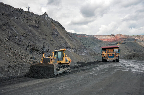 open cast dump truck drives alone industrial area of iron ore quarry