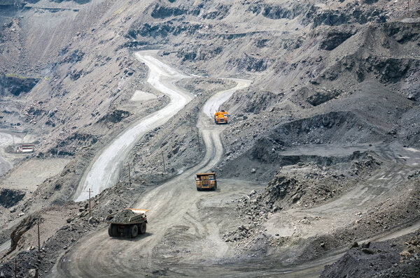 open cast dump truck drives alone industrial area of iron ore quarry