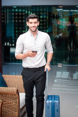 Handsome young bearded businessman with mobile phone