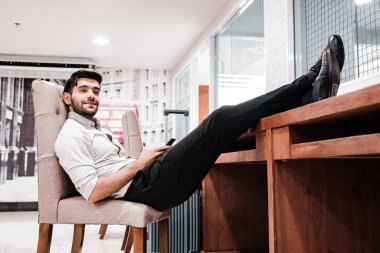 Handsome young bearded businessman with mobile phone