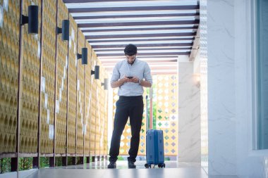 Handsome young bearded businessman with mobile phone