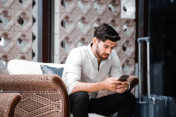 Handsome young bearded businessman with mobile phone