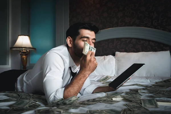 Handsome young bearded businessman with cash 
