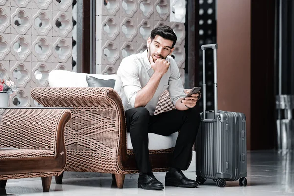 Handsome young bearded businessman with mobile phone