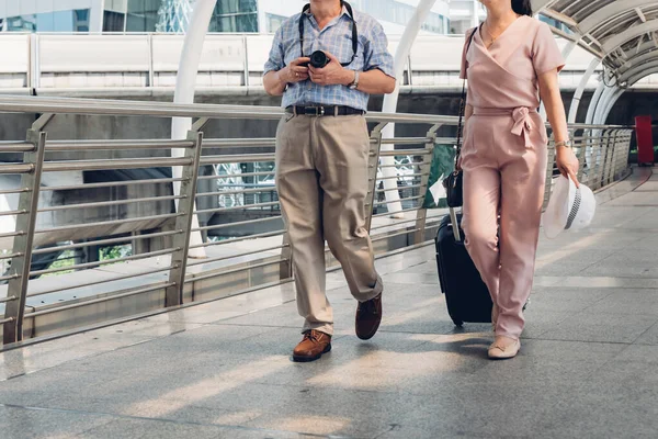 Asian couple walking on train station