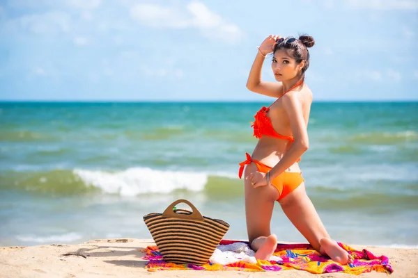 Asian sexy woman in orange bikini posing