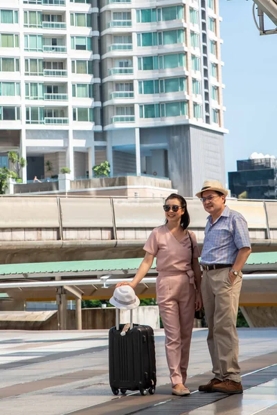 stock image Asian couple walking on train station