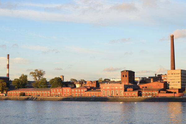 The old factory building on the banks of the Neva River in St.Petersburg at evening, Russia.