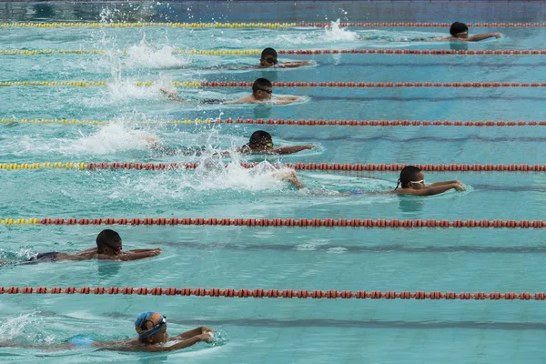 Meninos nadando ação corrida em pistas de piscina — Fotografia de Stock