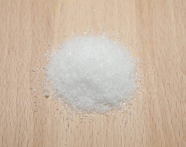 Sugar isolated on wooden plate — Stock Photo, Image