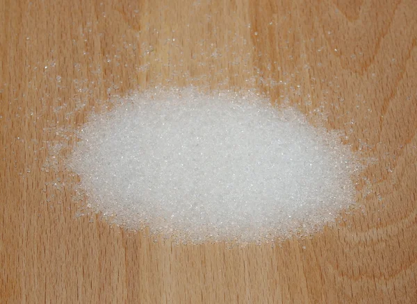 Sugar isolated on wooden plate — Stock Photo, Image