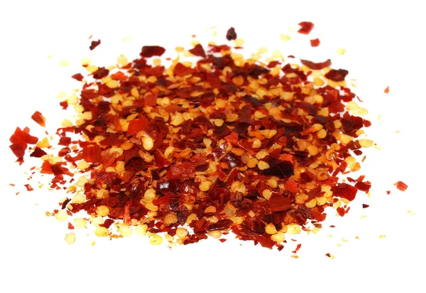 Pile schiacciato peperoncino rosso, fiocchi di peperoncino essiccato e semi isolati su sfondo bianco — Foto Stock