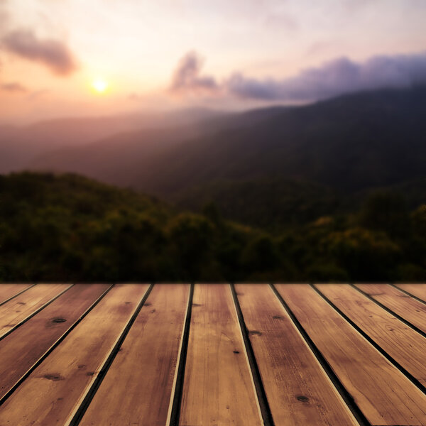 Sunset with mountain and wood floor