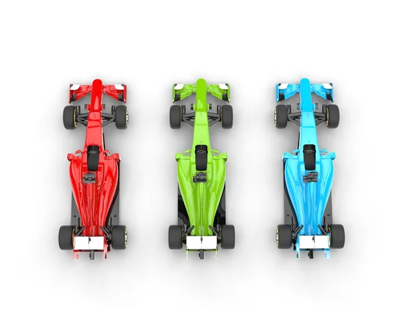 Red, green and blue formula one cars - top view — Stock Photo, Image