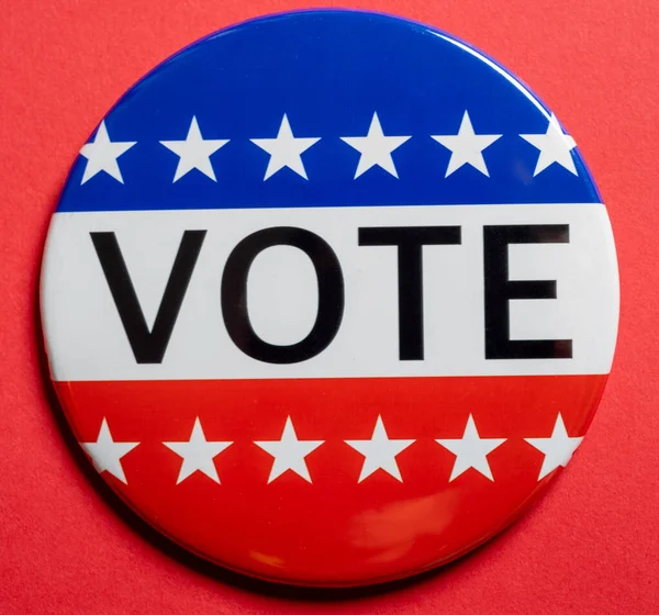 Vote buttons on red background with copy space. Election theme Stock Image