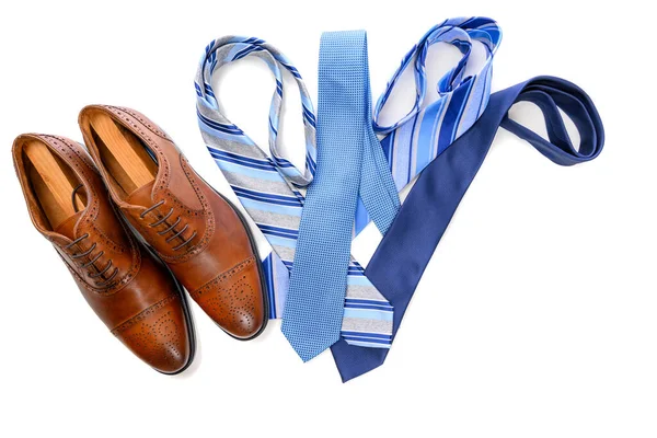 A pair of brown dress shoes with blue neckties on white background — Stock Photo, Image