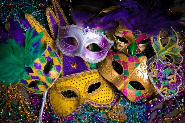 Group of Mardi Gras Mask on dark background with beads Stock Photo