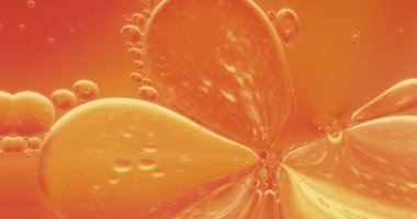 Portakal suyu damlalarının soyut canlandırılmış arka planı