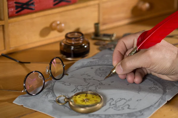 Adventurer drawing a map — Stock Photo, Image