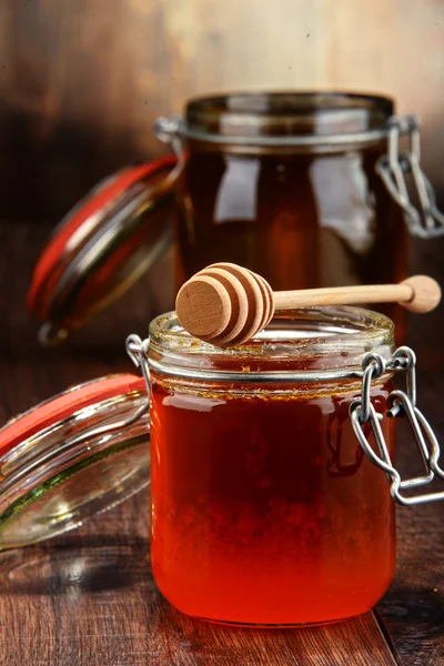 Composition with jars of honey on wooden table — Stock Photo, Image