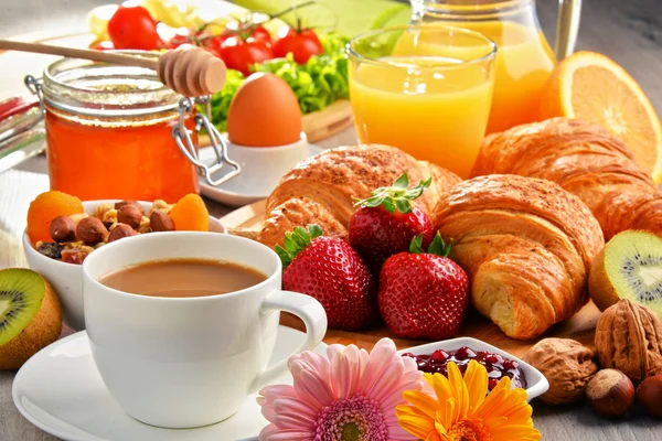 Breakfast consisting of croissants, coffee, fruits, orange juice — Stock Photo, Image