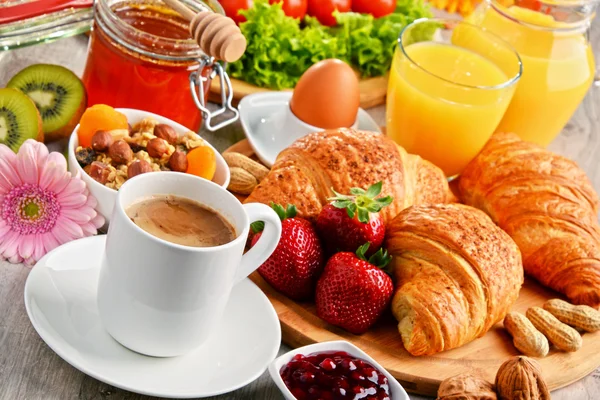 Breakfast consisting of croissants, coffee, fruits, orange juice — Stock Photo, Image