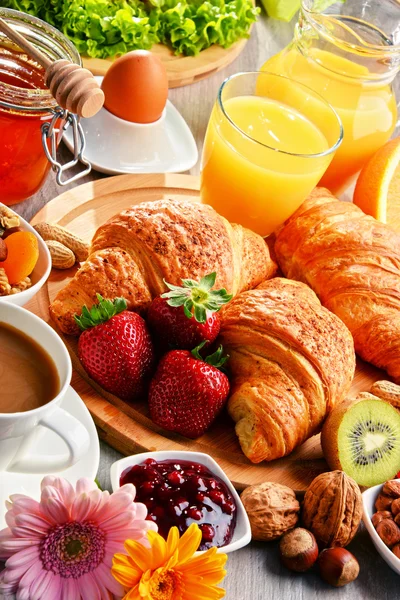 Breakfast consisting of croissants, coffee, fruits, orange juice — Stock Photo, Image