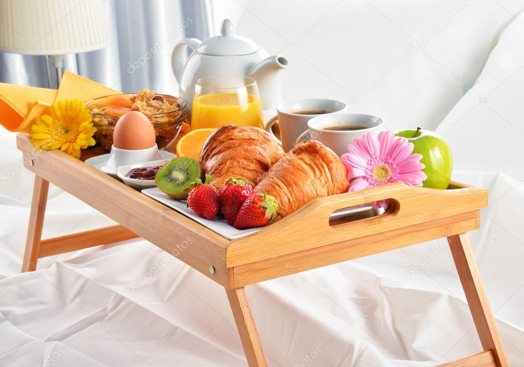 Breakfast tray in bed in hotel room — Stock Photo © monticello 108908284