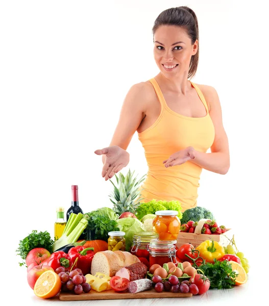 Young woman with variety of organic grocery products on white — Stock Photo, Image