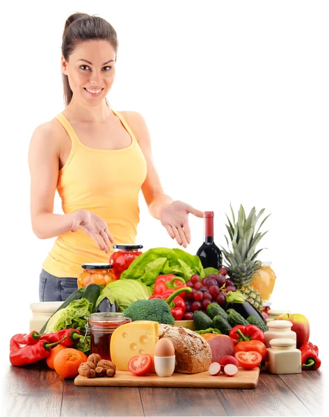 Young woman with variety of organic grocery products on white — Stock Photo, Image