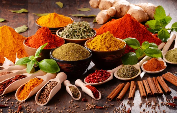 Variety of spices on kitchen table — Stock Photo, Image