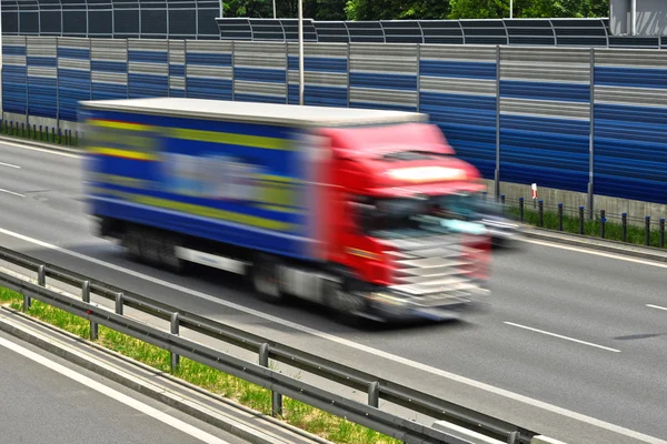 Large goods vehicle moving at full speed on six lane highway