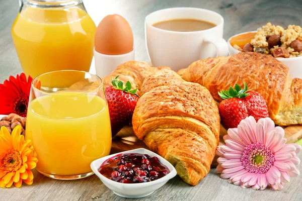 Breakfast consisting of croissants, coffee, fruits, orange juice Royalty Free Stock Images