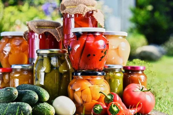 Frascos de verduras en escabeche y frutas en el jardín —  Fotos de Stock