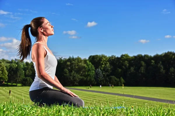 Yoga, meditasyon sırasında genç kadın parkta — Stok fotoğraf