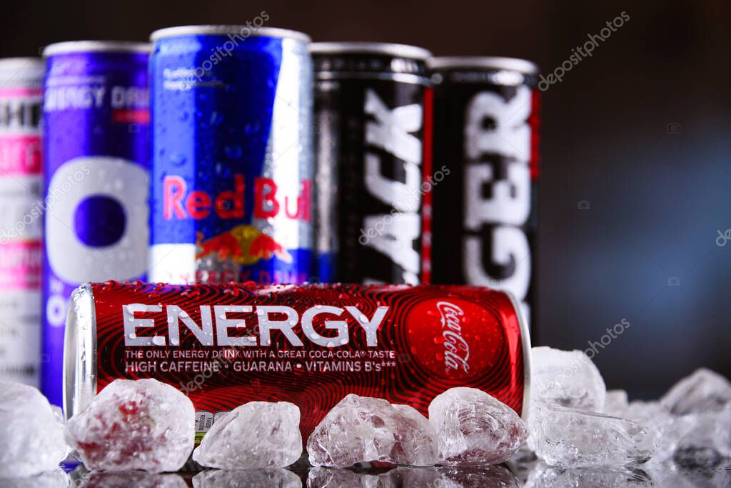 POZNAN, POLAND - MAY 13, 2021: Cans of popular global energy drinks, beverages containing stimulant drugs and marketed as providing mental and physical stimulation