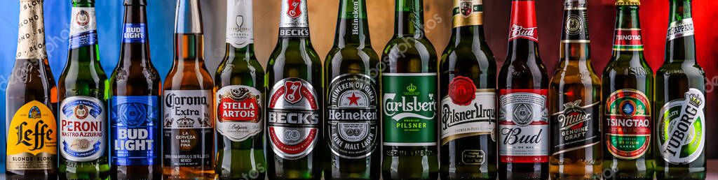 POZNAN, POL - AUG 06, 2021: Bottles of famous global beer brands including Heineken, Becks, Bud, Miller, Corona, Stella Artois and Carlsberg
