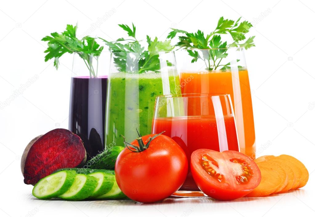 Glasses with fresh vegetable juices isolated on white