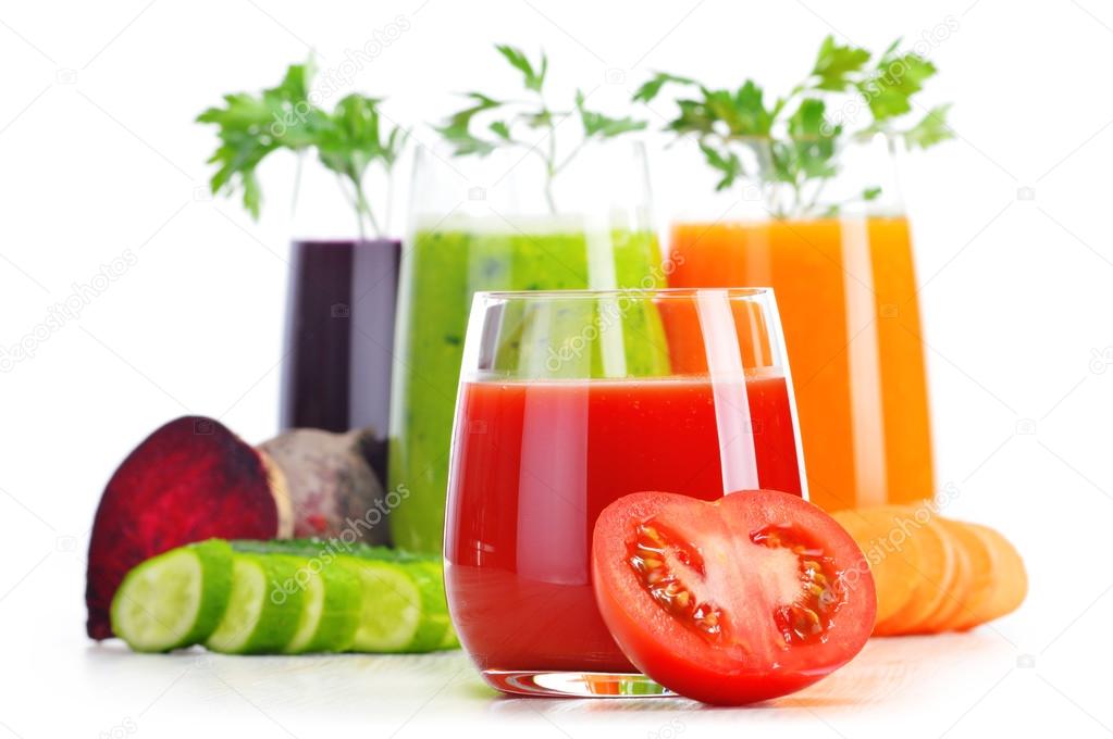 Glasses with fresh vegetable juices isolated on white