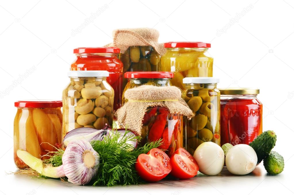 Composition with jars of pickled vegetables. Marinated food