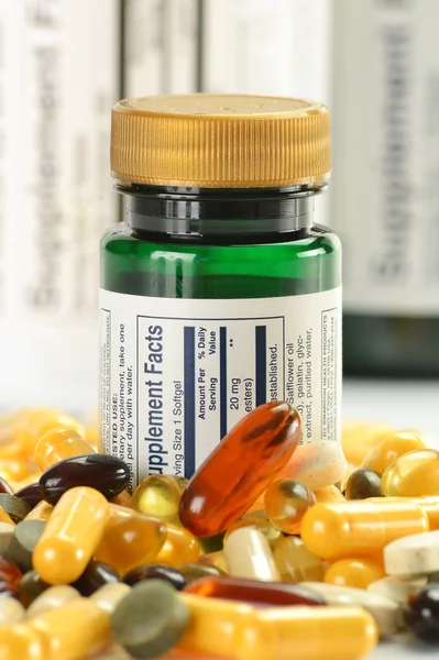 Composition with dietary supplement capsules and containers — Stock Photo, Image