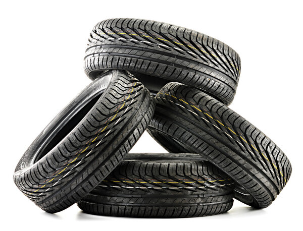 Four new black tires isolated on white