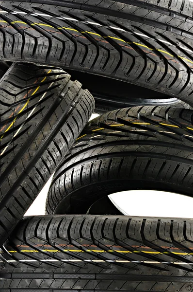 Four new black tires isolated on white — Stock Photo, Image