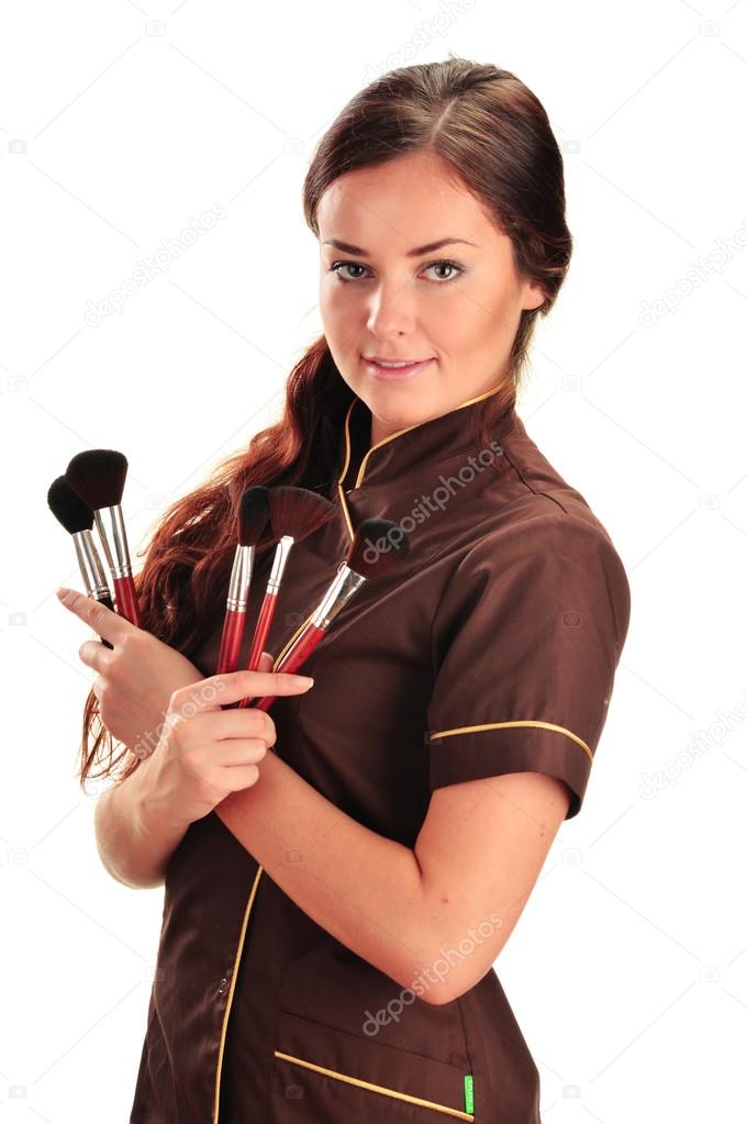 Professional beautician holding brushes