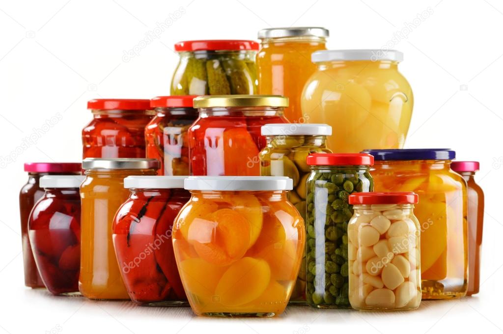 Jars with fruity compotes jams and pickled vegetables isolated