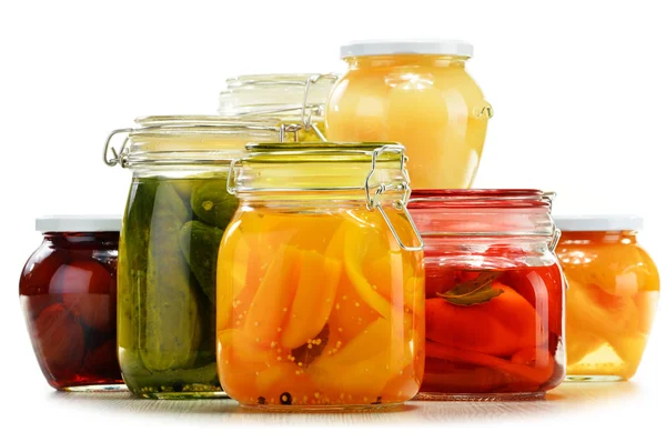 Jars with pickled vegetables and fruity compotes on white — Stock Photo, Image