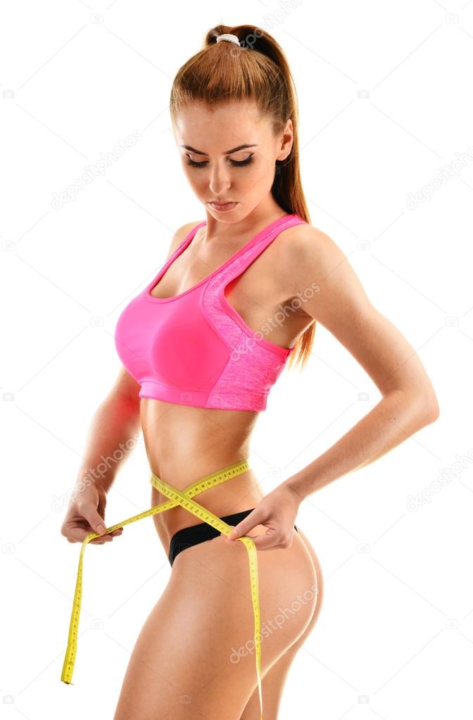 Sexy young woman measuring herself. Weight loss