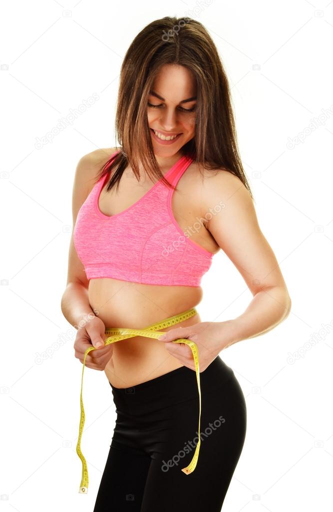 Young woman measuring herself. Weight loss